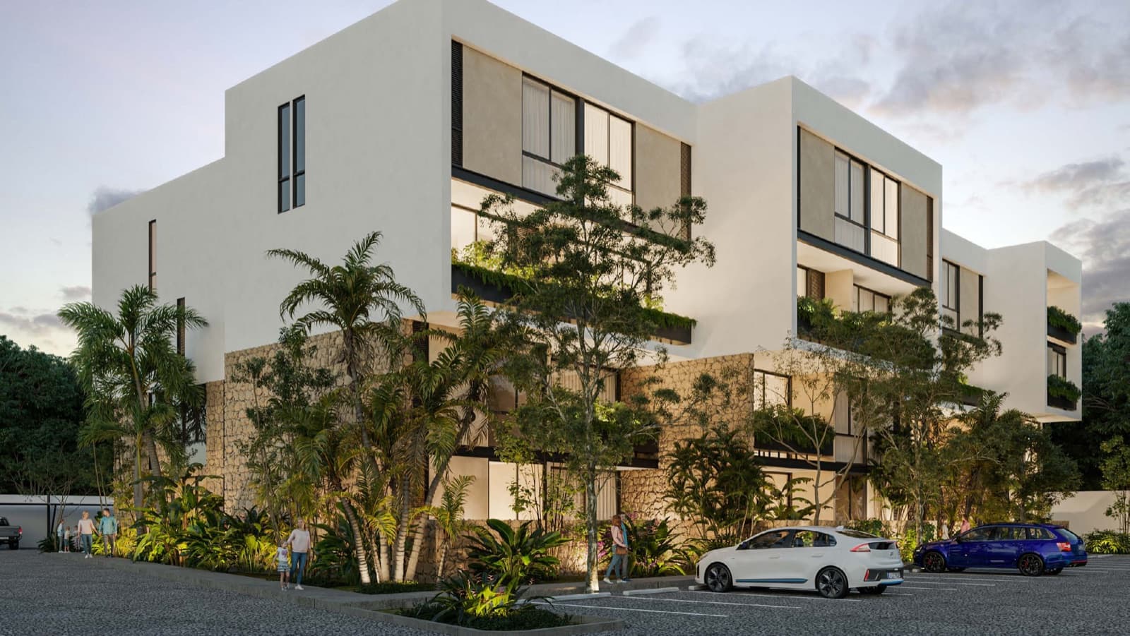 Fachada de un edificio de departamentos con vegetacion en Cholul, Merida